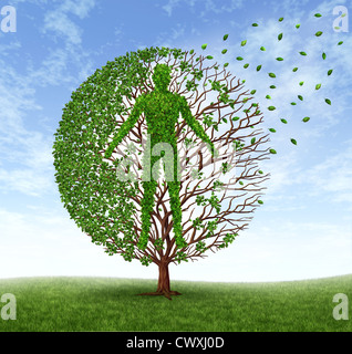 Aging and disease with a tree and leaves with branches in the shape of an old human losing foliage as a symbol of dying and suffering the loss of health due to age related illness as alzheimer and dementia or terminal cancer. Stock Photo