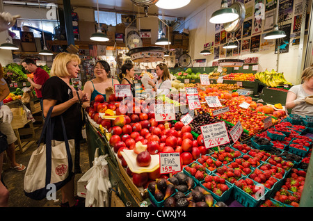 Inside Pike Place Market, Seattle, USA - with people buying food from the market stalls Stock Photo