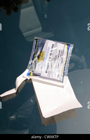 A City of Westminster parking ticket (penalty charge notice) stuck on the windscreen of a car in London, UK. July 2012 Stock Photo