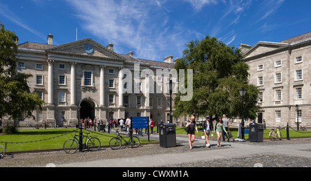 University students walking on campus at Trinity College, Dublin, Ireland in front of the School of Law building in summer Stock Photo