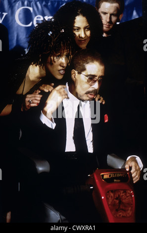 Comedian Richard Pryor, seated, receives the Mark Twain Comedy Award as family members look on at the Kennedy Center October 20, 1998 in Washington, DC (L-R) Daughters Rain Pryor and Elizabeth Pryor. Stock Photo