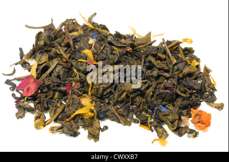 Green tea with flower petals and spices on a white background. Stock Photo
