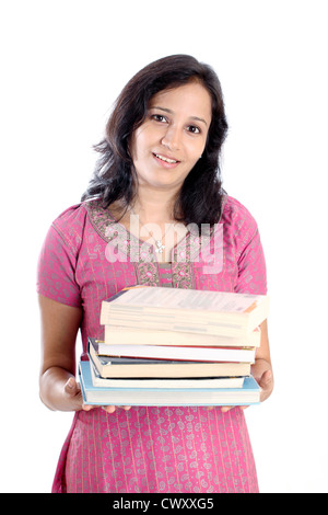 Young female college student holding stack of books against white Stock Photo