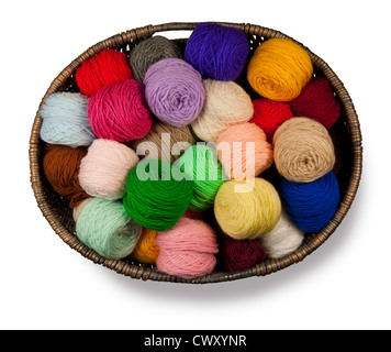 Wicker basket full of brightly coloured wool isolated on a white background Stock Photo