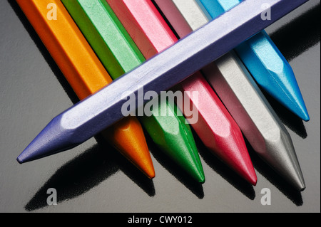 Pearl wax crayons on a black background. Stock Photo