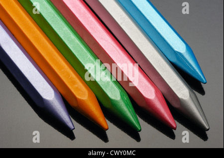 Pearl wax crayons on a black background. Stock Photo