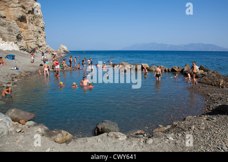 People bathing in the Hot Springs at Embros Thermes on the Greek island of Kos - hot valcanic gasses warm the Agean sea Stock Photo