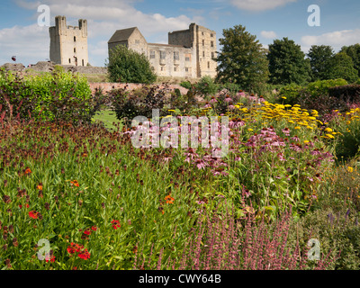 Helmsley Castle overlooking the Helmsley Walled Garden with a show of summer flowers Stock Photo