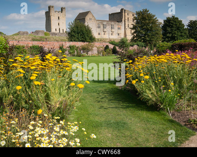 Helmsley Castle overlooking the Helmsley Walled Garden with a show of summer flowers Stock Photo