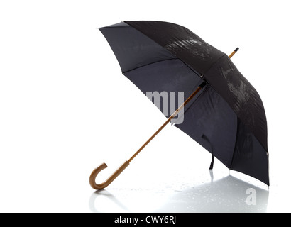 A black umbrella with a wooden handle opened on a white background Stock Photo