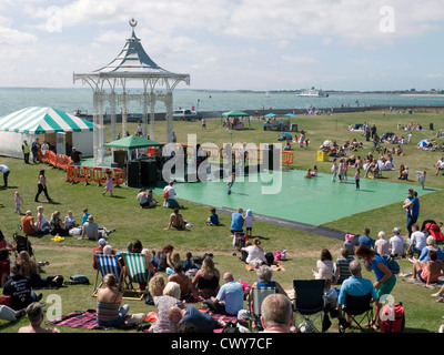 crowds listen to a free music concert at the bandstand on castle fields at southsea hampshire