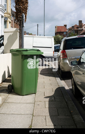 workers van and recycling bin blocking pavement Stock Photo