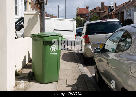 workers van and recycling bin blocking pavement Stock Photo