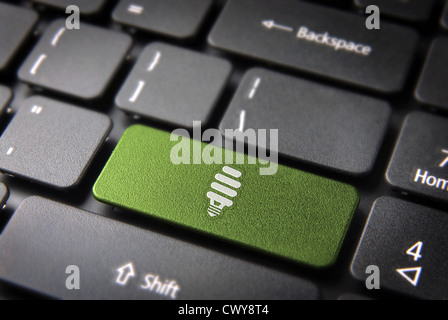 Green energy key with eco bulb light icon on laptop keyboard. Included clipping path, so you can easily edit it. Stock Photo
