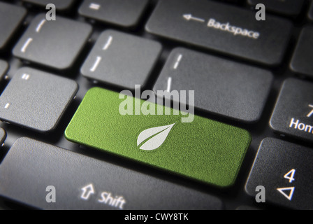 Green energy key with leaf icon on laptop keyboard. Included clipping path, so you can easily edit it. Stock Photo