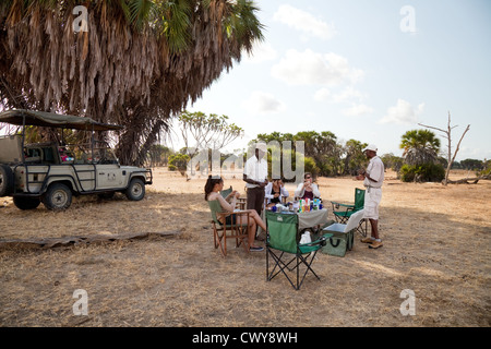 Tourists on a jeep safari stop for breakfast, the Selous Game reserve Tanzania africa Stock Photo