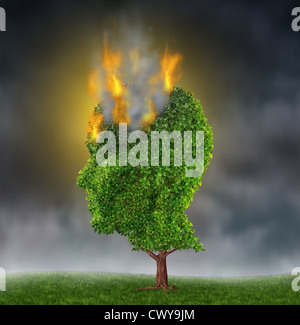 Emotional stress and suffering with a tree in the shape of a human head burning in flames on a night sky as a medical brain concept representing the extreme anguish and pain of anxiety and depression.