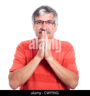 Serious senior man praying, isolated on white background. Stock Photo