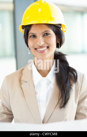 pretty young female construction worker in office Stock Photo