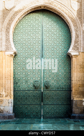 Famous landmark in Spain. Beautiful cathedral Mezquita of Cordoba, Andalucia. Green door with arch in old arabic style. Stock Photo