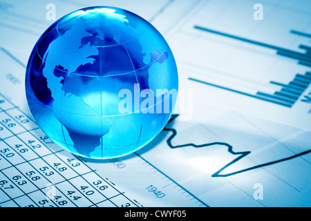 Globe showing North America and resting on financial papers Stock Photo