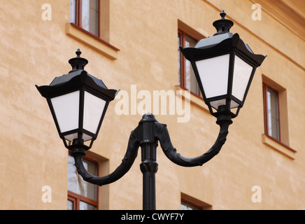 retro fashioned street lamp in front of building Stock Photo