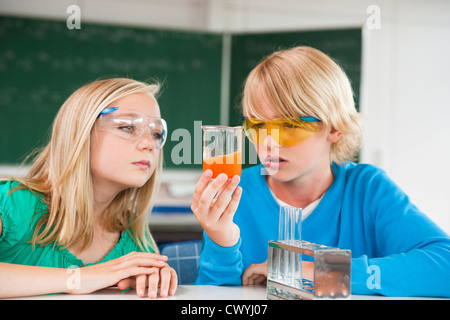 Schoolboy and schoolgirl experimenting in chemical class Stock Photo