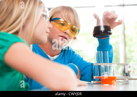 Schoolboy and schoolgirl experimenting in chemical class Stock Photo