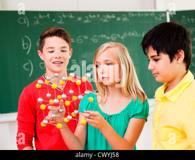 Pupils in class holding molecular model Stock Photo