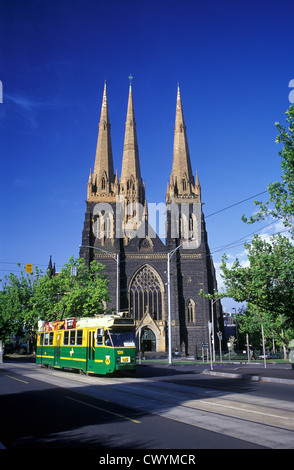 Australia, Victoria, Melbourne, St Patrick's Cathedral and city bound tram on Macarthur Street near Parliament buildings. Stock Photo