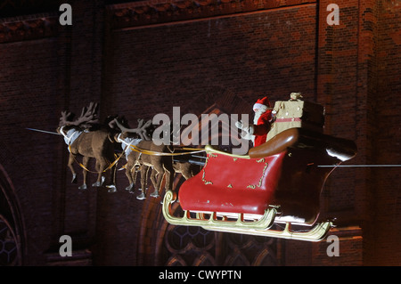 Santa Claus in his sleigh flying on Christmas market at Opernpalais in front of Friedrichwerdersche Kirche, Berlin, Germany. Stock Photo