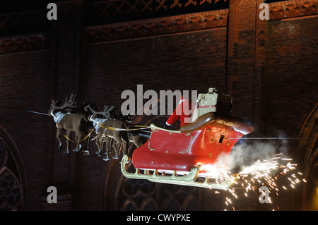 Santa Claus in his sleigh flying on Christmas market at Opernpalais in front of Friedrichwerdersche Kirche, Berlin, Germany. Stock Photo