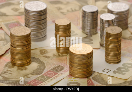 stacks of coins on background of banknotes Stock Photo