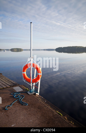 Safety equipment. Bright red lifebuoy on the pier Stock Photo