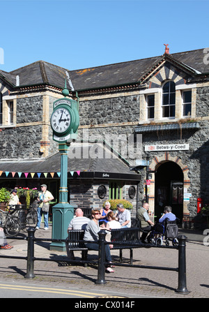 People sitting outside Betws y Coed railway station North Wales, UK Stock Photo