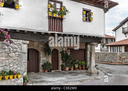 Old house of typical Cantabrian construction with zaguan and flowers on its facade in the village of Escalante, Cantabria, Spain, Europe Stock Photo
