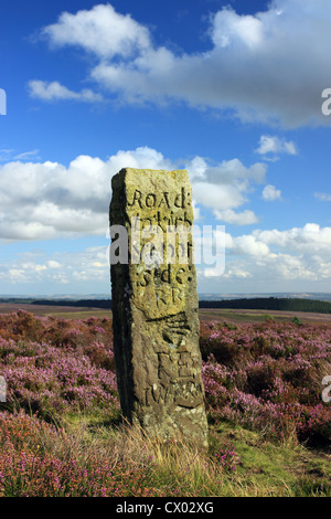 A stone signpost on the moors of the North York Moors National Park, North Yorkshire, points towards the town of Kirkbymoorside Stock Photo