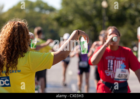 Marathon volunteer offering water to runners - USA Stock Photo