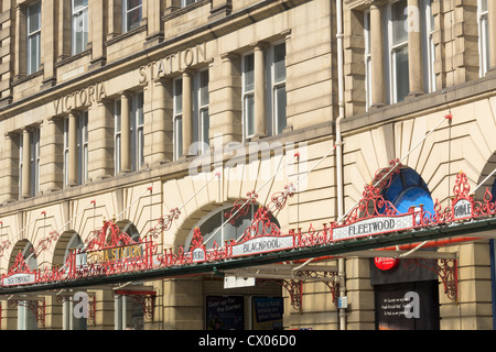 Iron and glass canopy on the main facade of Manchester Victoria railway station showing destinations of the L & Y Railway Stock Photo