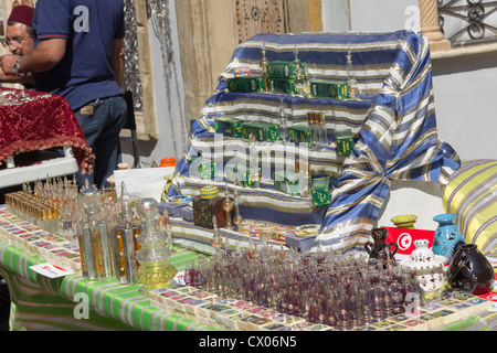 Herbal cosmetics and Tunisian glassware on a stall at a Tunisian tourism promotional street market in Manchester in May 2012. Stock Photo