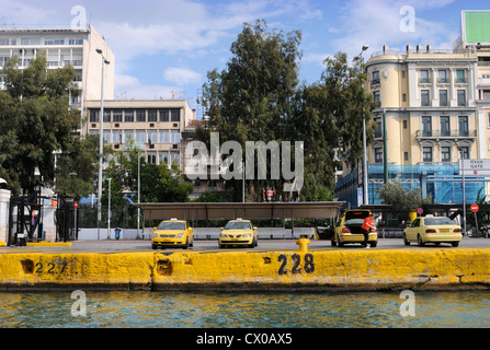 Taxi drivers waiting for fares near the passenger ferries at the port of Piraeus in Athens Greece Stock Photo
