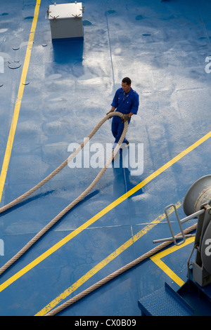 deck hand ship pulling uk mooring line rope hauser Stock Photo