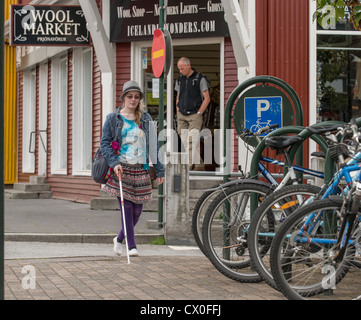 Blind woman using a cane in the city,  Reykjavik Iceland Stock Photo