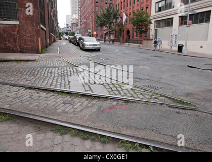 DUMBO, Brooklyn streets with cobblestone and old rail trolley tracks at the corner of Plymouth and Jay Streets. Stock Photo