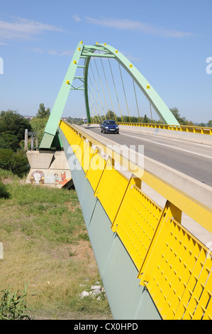 Modern arched metal engineering bridge on D6572 over Gard Bouches du Rhone between Saint Gilles and Arles in southern France Stock Photo