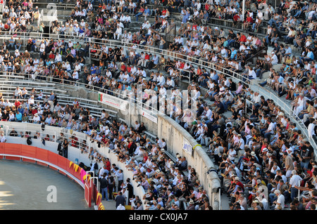 Huge crowds in Roman Arena or Amphitheatre in Arles southern France for spectacle of Bull Fight or Corrida Stock Photo