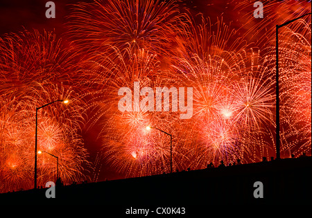 FPeople watch Fourth of July Fireworks from elevated overpass. Stock Photo