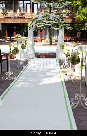 Wedding arch with flowers decoration in tropical resort Stock Photo