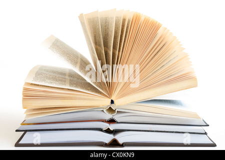 Stack of open old fanned hardcover leather bound books Stock Photo