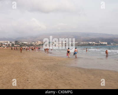 A long morning stroll is enjoyed along the beach between Playa Ingles and Maspalomas in Gran Canaria Stock Photo